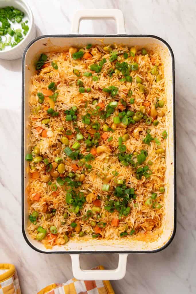White square enamel casserole dish filled with veggie rice.