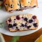 Slice of blueberry bread on a marble circle.