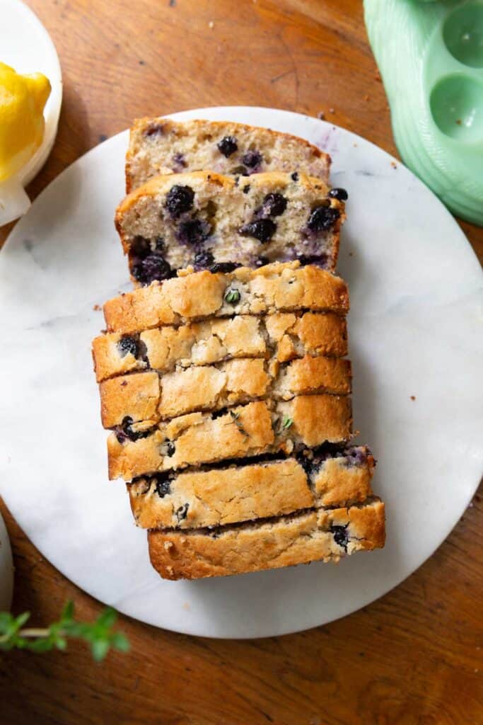 Top down view of entire loaf of blueberry bread cut into 1-inch slices.