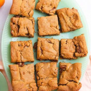 Close up of pumpkin bars on a jade green platter.
